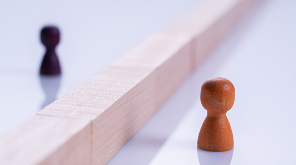 barrier Photo of 2 beings separated by a barrier. Illustrating the Barriers to adoption discussed in the article.